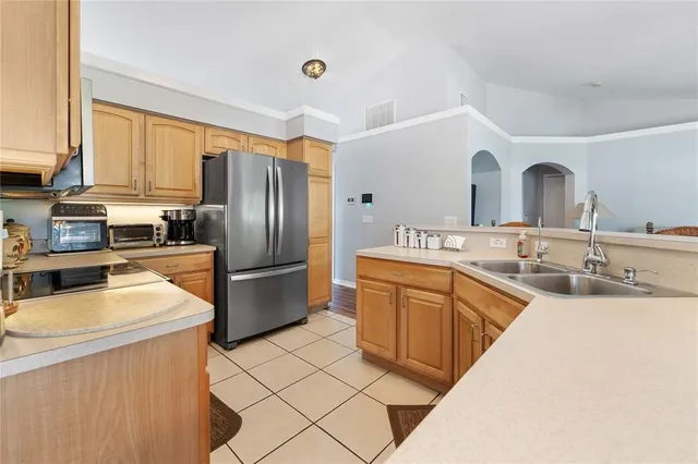 a kitchen with stainless steel appliances granite countertop a refrigerator sink and cabinets