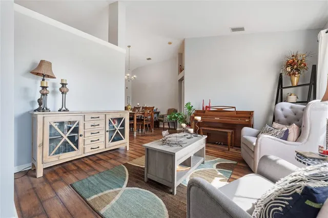 a living room with furniture a rug and a wooden floor