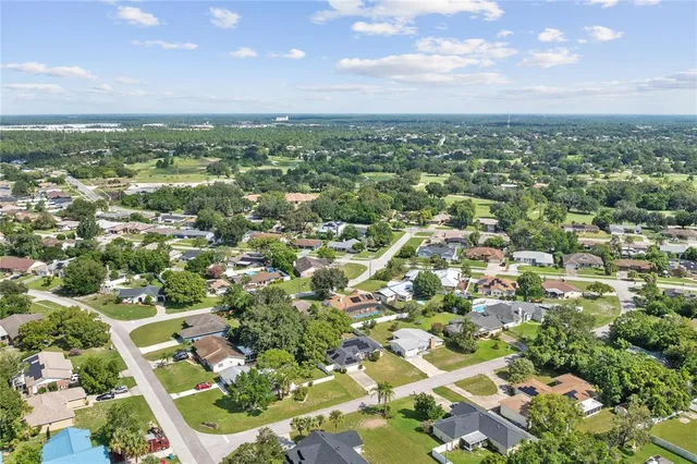 an aerial view of residential houses with city view