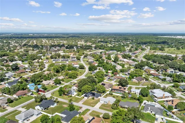 an aerial view of residential building with green space