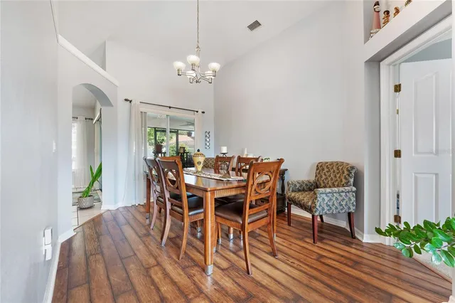 a view of a dining room with furniture wooden floor and chandelier