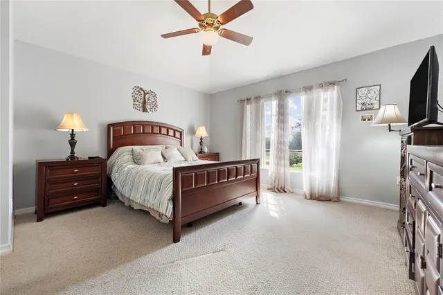 a bedroom with a bed closet and flat tv screen