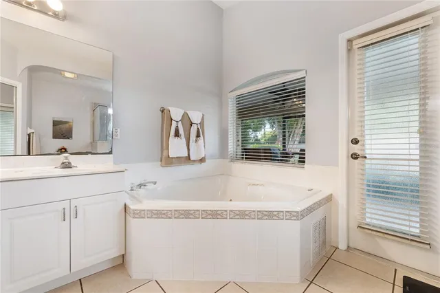 a bath tub sitting next to a bathroom sink