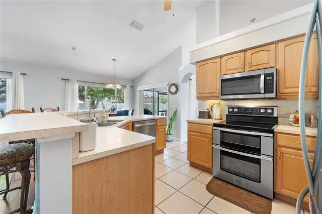 a kitchen with a stove a sink and a microwave
