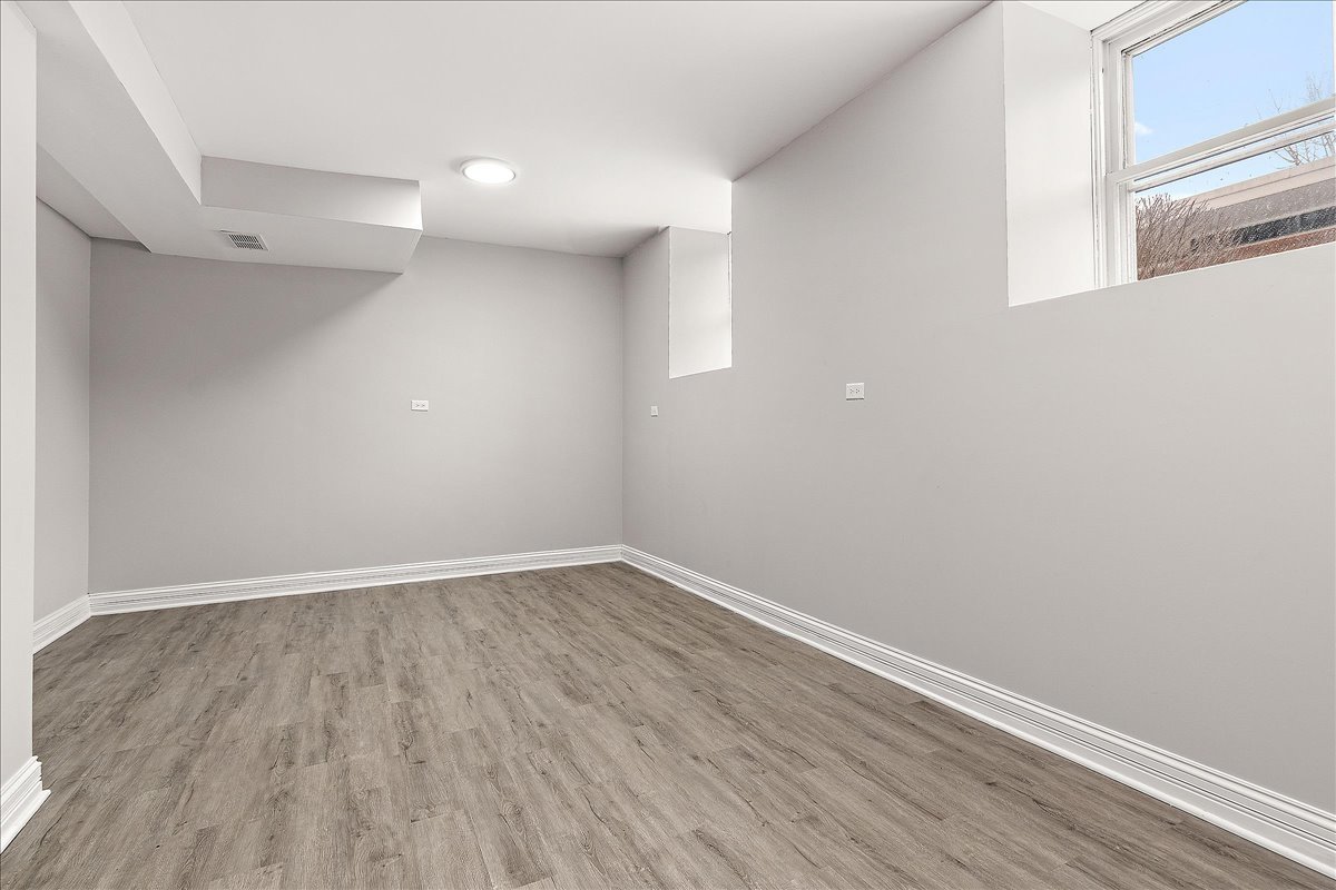 200 West Crawford Street Peotone, IL 60468 - Photo 31 of 42 a view of an empty room with wooden floor and a window