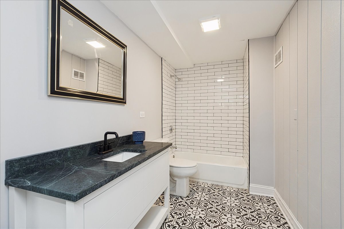 200 West Crawford Street Peotone, IL 60468 - Photo 32 of 42 a bathroom with a sink a toilet and shower