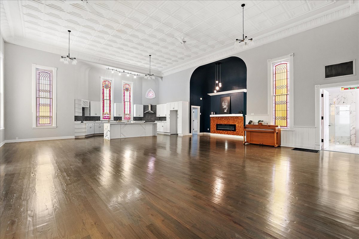 200 West Crawford Street Peotone, IL 60468 - Photo 6 of 42 a view of a room with wooden floor and a ceiling fan