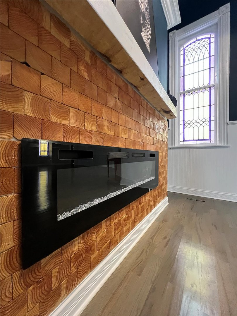 200 West Crawford Street Peotone, IL 60468 - Photo 8 of 42 a view of an empty room with wooden floor and a fireplace