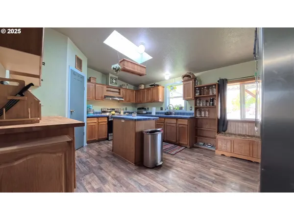 a room with kitchen island granite countertop lots of counter top space