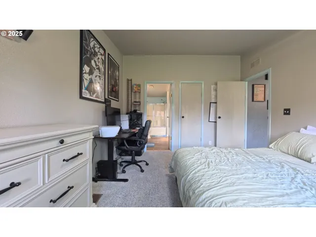 a living room with furniture and a dresser