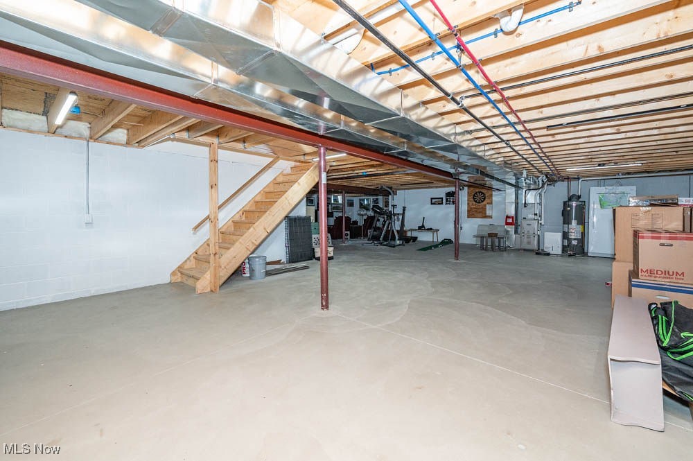 6580 Abbey Road North Canfield, OH 44406 - Photo 23 of 32 Unfinished basement with water heater and stairs