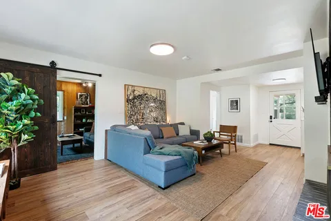 a living room with furniture a window and a bookshelf