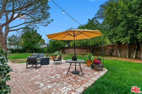 a view of a backyard with large trees