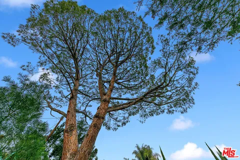 a view of a hallway view with wooden floor and a bathroom