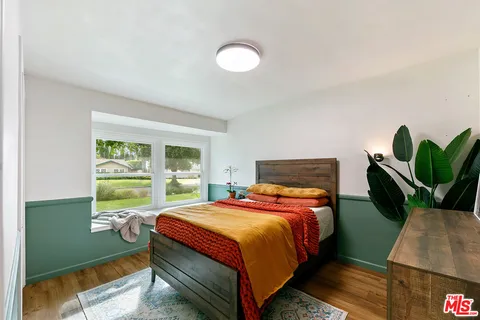 a hallway with a view of bedroom with a window