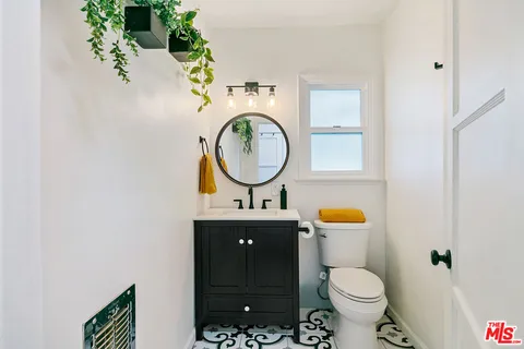 a view of kitchen with hallway and wooden floor