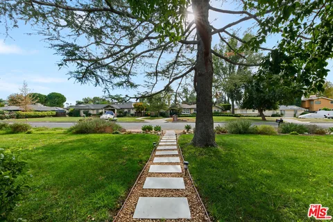 a living room with furniture wooden floor and a large window