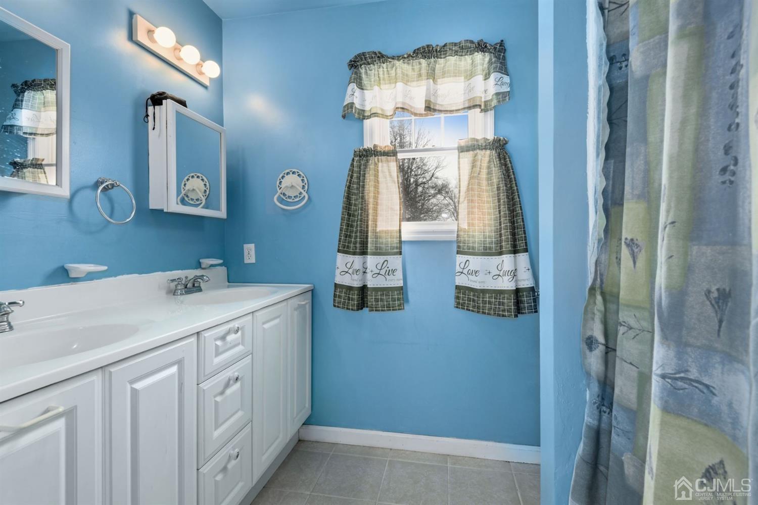 52 Caldwell Road Edison, NJ 08817 - Photo 15 of 17 a room with a chandelier fan and kitchen view