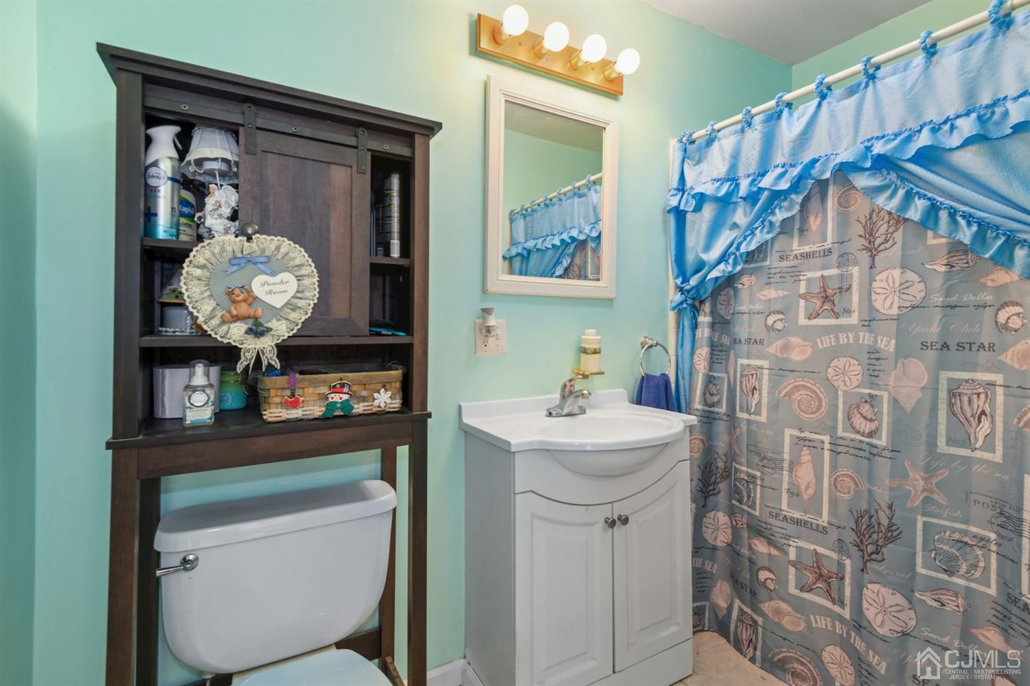 52 Caldwell Road Edison, NJ 08817 - Photo 9 of 17 a bathroom with a sink a mirror and a toilet