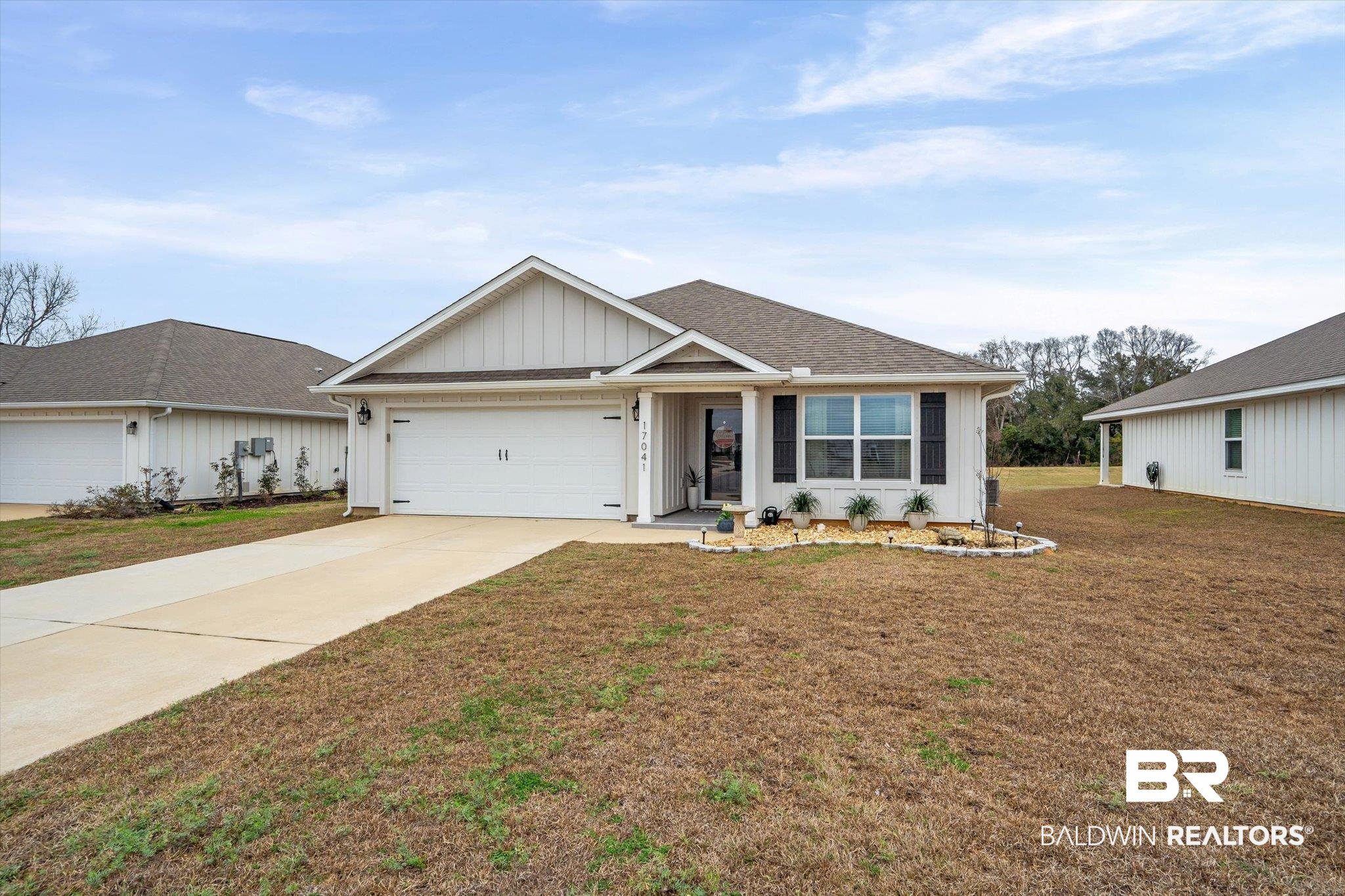 17041 Muse Street Loxley, AL 36551 - Photo 30 of 44 Single story home featuring a front lawn, driveway, board and batten siding, a garage, and a shingled roof