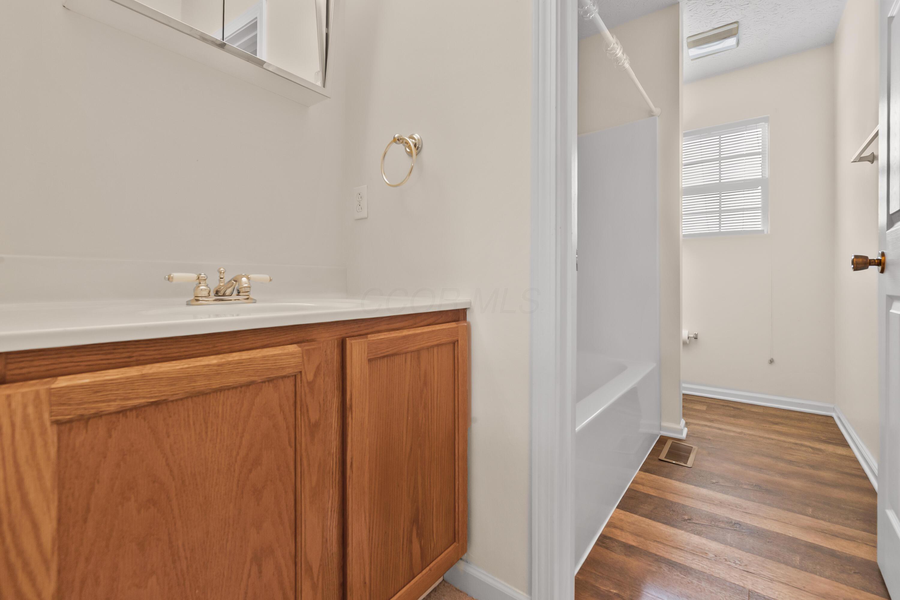 30 Tabilore Loop Delaware, OH 43015 - Photo 36 of 55 • New light sand carpet ~ 2025 • Ivory painted walls • Wall mounted light • Mirrored medicine cabinet • Enclosed vanity with single bowl, cultured marble sinktop