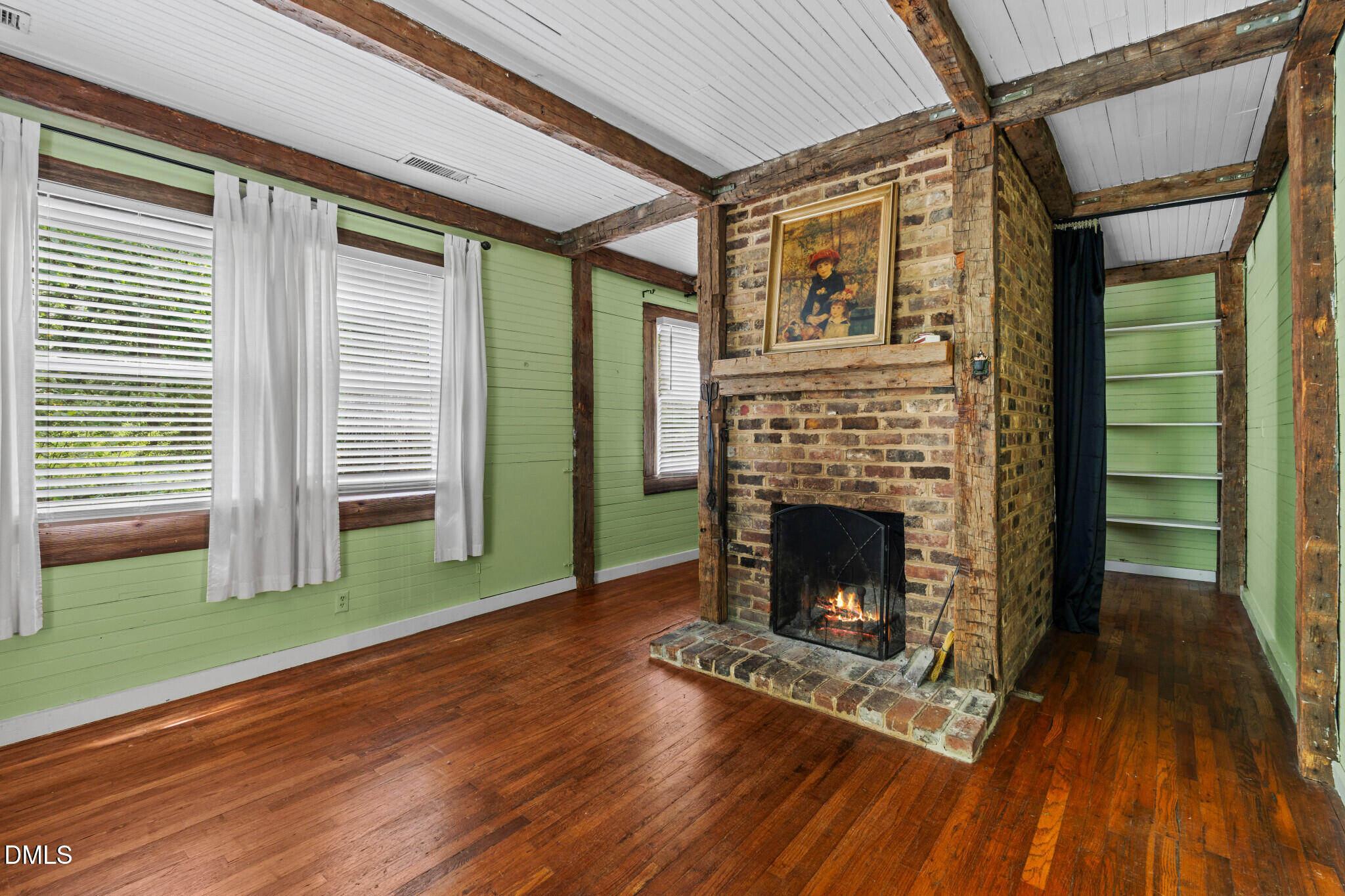 3415 Mt Willing Road Efland, NC 27243 - Photo 3 of 36 a living room with a fireplace and a wooden floor