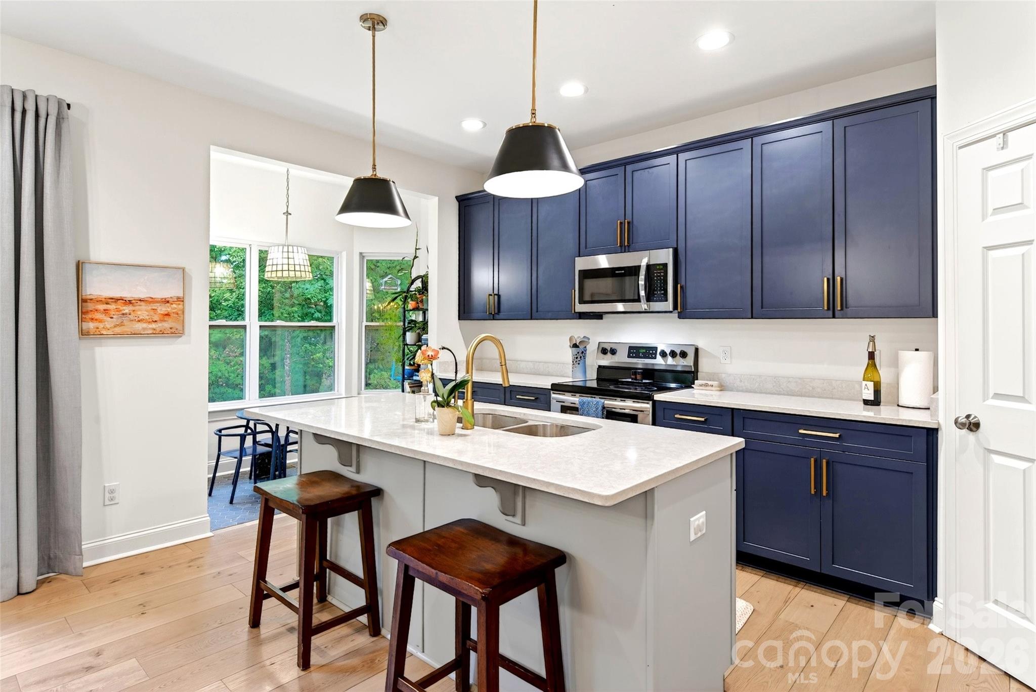132 Maple Ridge Drive Old Fort, NC 28762 - Photo 15 of 40 a kitchen with stainless steel appliances granite countertop a stove a sink dishwasher a microwave oven a stove with a dining table and chairs
