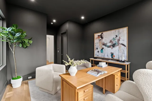 a living room with furniture and flowers