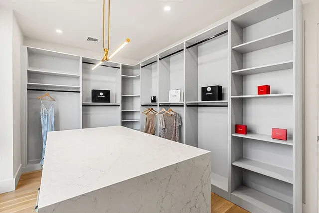 a kitchen with stainless steel appliances cabinets a sink and a refrigerator