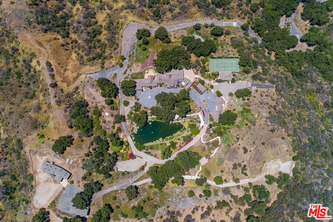 3100 Mandeville Canyon Road Los Angeles, CA 90049 - Photo 2 of 27 an aerial view of residential houses with outdoor space