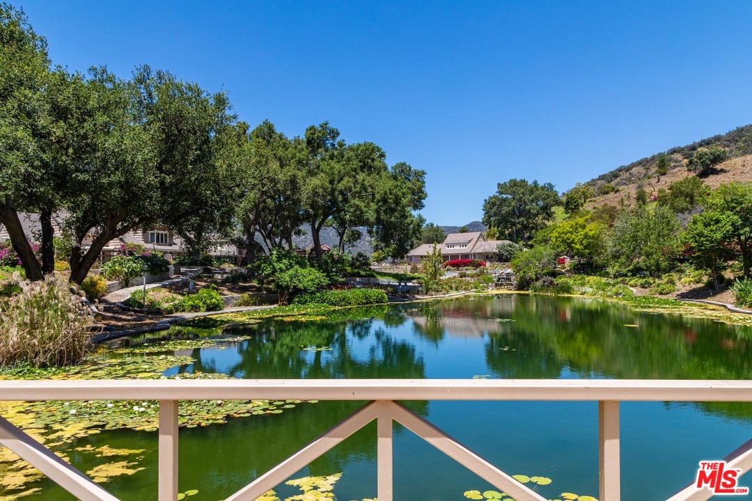 3100 Mandeville Canyon Road Los Angeles, CA 90049 - Photo 11 of 27 a view of a lake from a balcony
