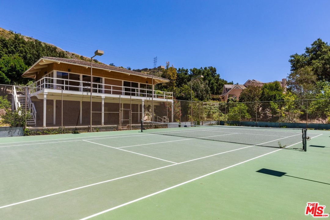 3100 Mandeville Canyon Road Los Angeles, CA 90049 - Photo 17 of 27 a view of a tennis court