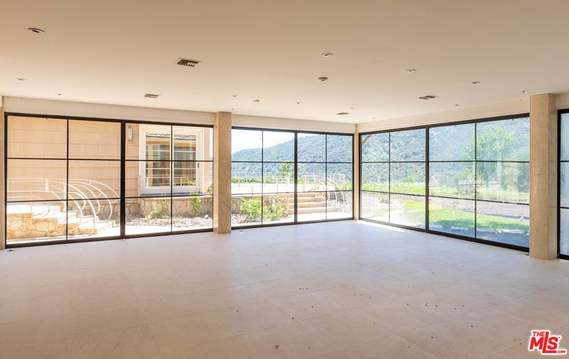 3100 Mandeville Canyon Road Los Angeles, CA 90049 - Photo 25 of 27 a view of an empty room with a large window