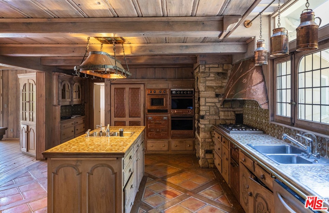 3100 Mandeville Canyon Road Los Angeles, CA 90049 - Photo 26 of 27 a kitchen with a sink and cabinets