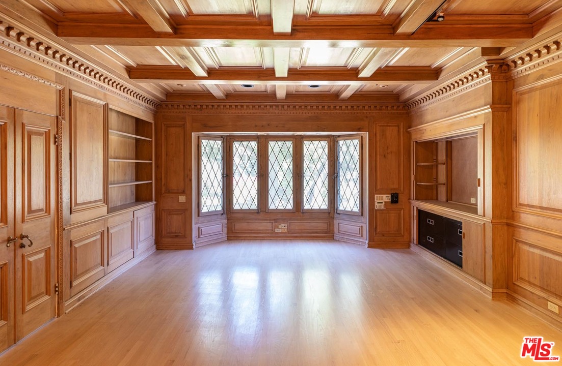 3100 Mandeville Canyon Road Los Angeles, CA 90049 - Photo 27 of 27 a view of empty room with wooden floor and windows