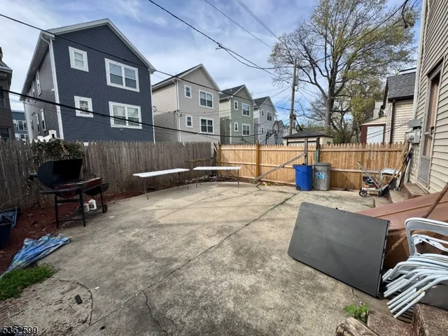 a backyard of a house with outdoor seating