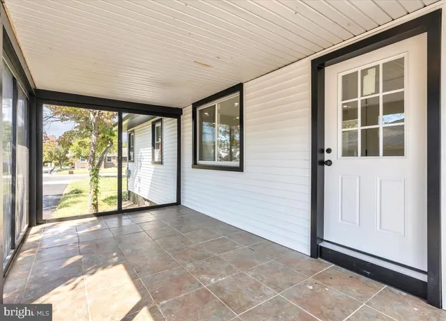 a view of a house with a yard and porch