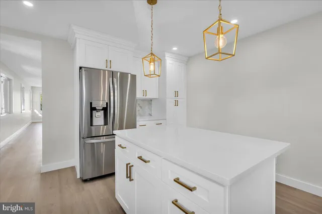a kitchen with stainless steel appliances a refrigerator and a stove