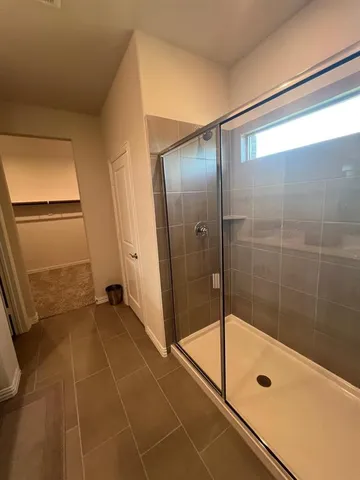 a bathroom with a shower and a mirror