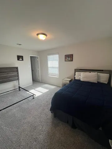 a bedroom with a bed and window