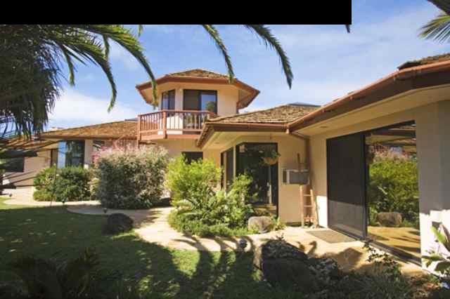1390 Kokomo Road Haiku, HI 96708 - Photo 1 of 30 a front view of a house with garden