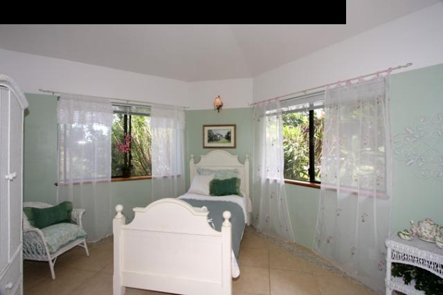1390 Kokomo Road Haiku, HI 96708 - Photo 19 of 30 a living room with furniture and a window