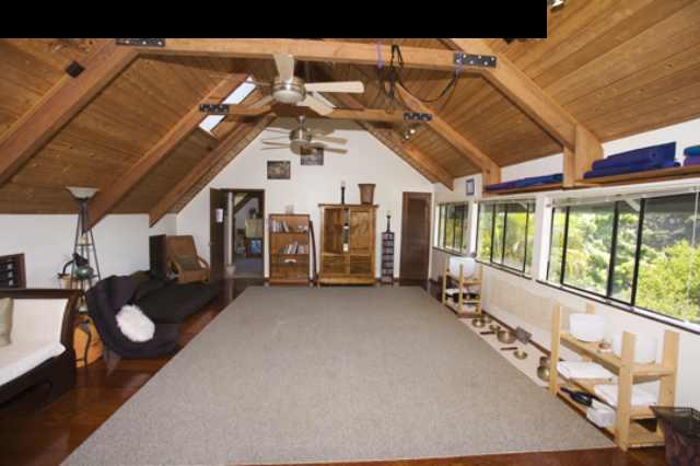 1390 Kokomo Road Haiku, HI 96708 - Photo 9 of 30 a view of a porch with furniture and a floor to ceiling window