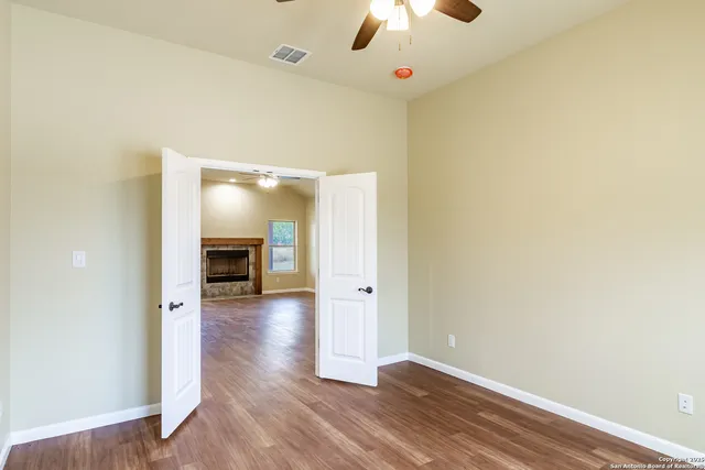 an empty room with wooden floor and workspace