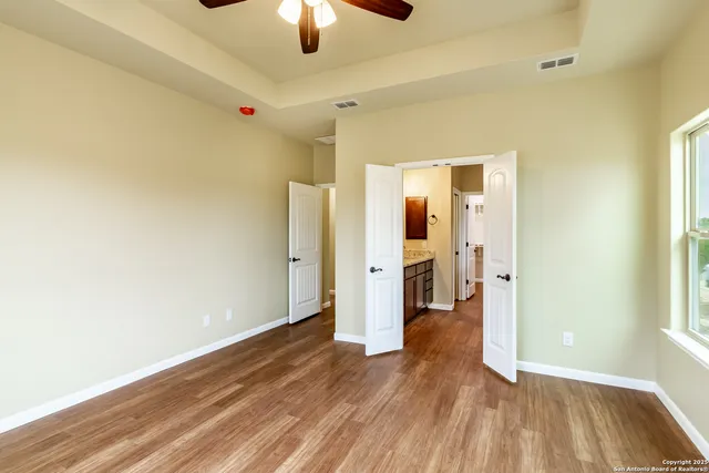 a view of a livingroom with wooden floor and chandelier