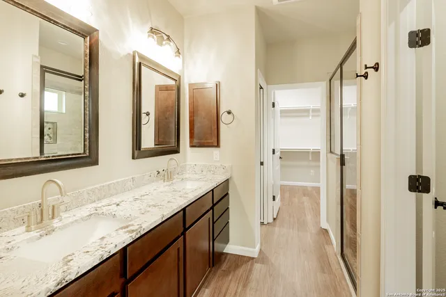 a bathroom with a granite countertop sink mirror and double