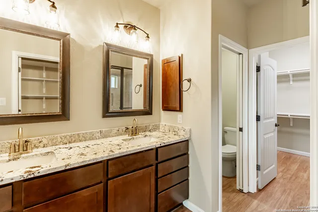 a bathroom with a double vanity sink and mirror