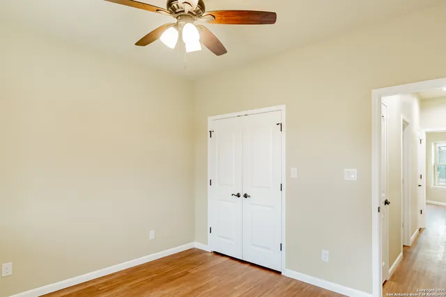 a view of a room with wooden floor