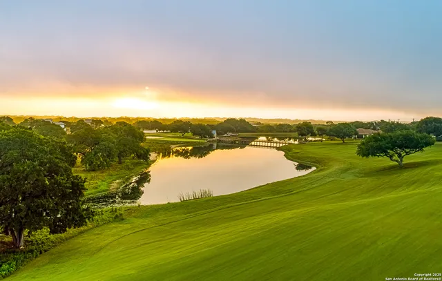 a view of a lake with houses in the background