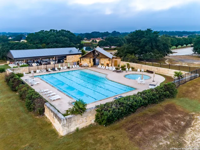 an aerial view of a house having swimming pool